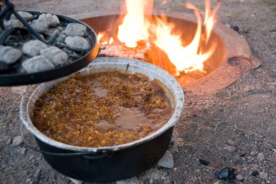 Making Peach Cobbler with a Dutch Oven Over a Campfire