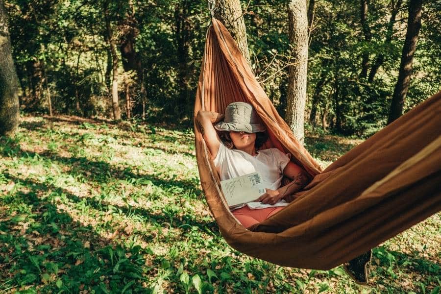 Woman Taking a Nap in a Hammock at her Campsite